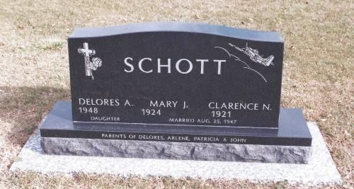 A black granite tombstone engraved with 