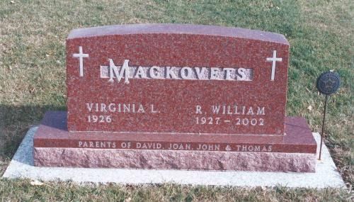 A red granite gravestone for Virginia L. and R. William Magkovets, listing their four children, in a grassy cemetery.