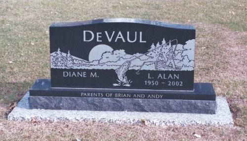 A black granite gravestone engraved with 
