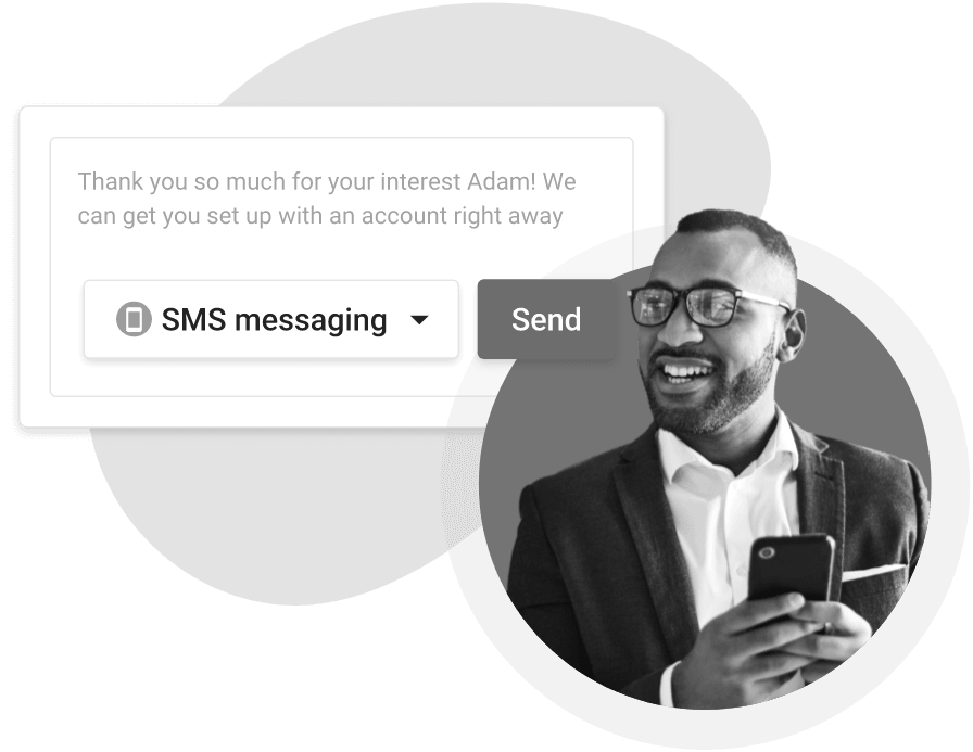 A man in a suit and glasses is holding a cell phone.