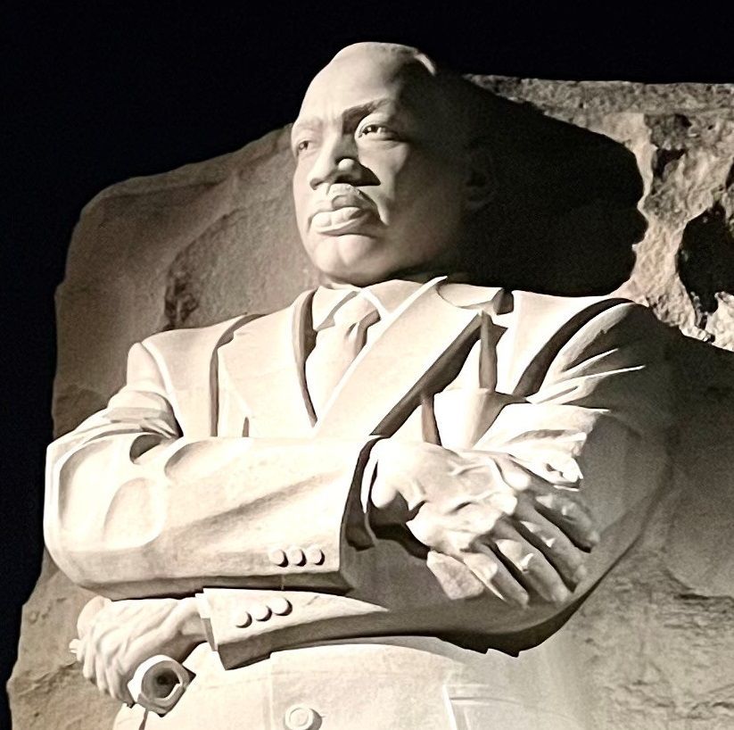 A statue of martin luther king jr. with his arms crossed