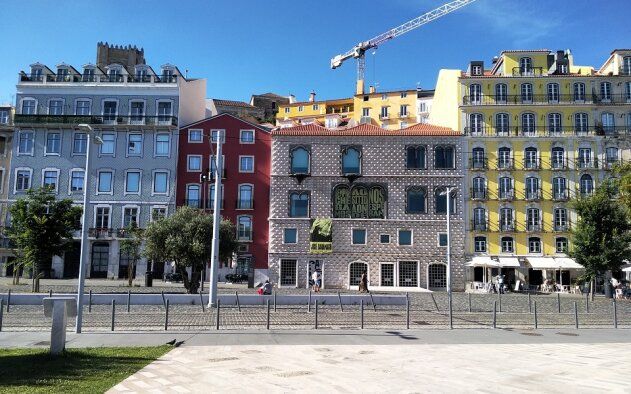 Uma fileira de edifícios com um guindaste ao fundo