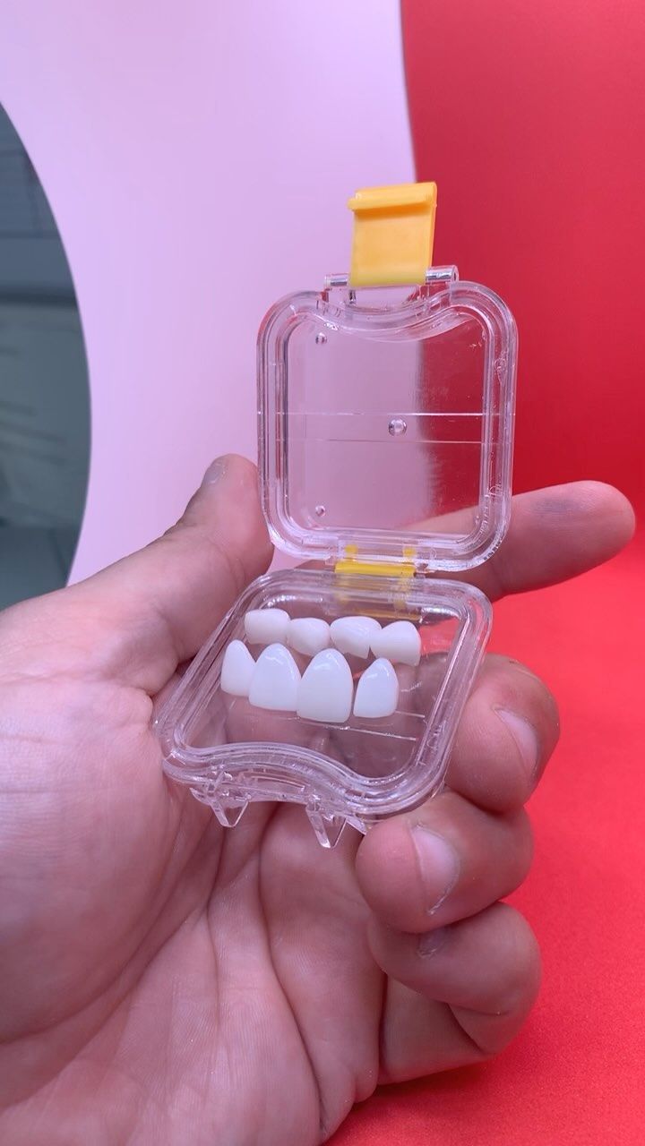 Hand Holding a Clear Case With a Set of White — AB Esthetic Dental Laboratory in Sunshine Coast, QLD