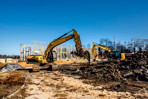 A Group Of Construction Vehicles Are Working On A Construction Site - Millville, CA - Concrete Construction Excavating Inc.