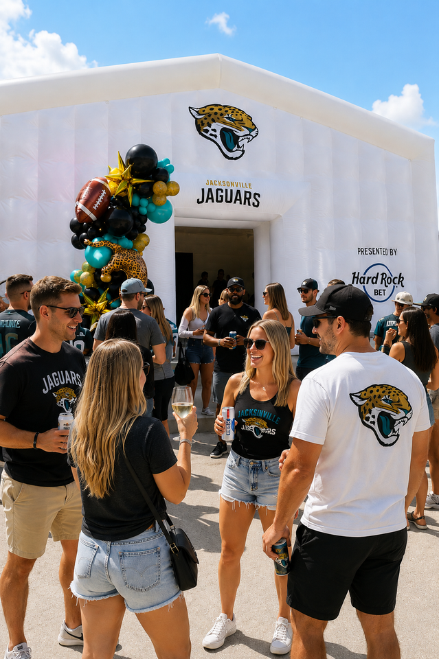 Black-and-gold balloon arch framing a Jaguars inflatable tunnel at a football event