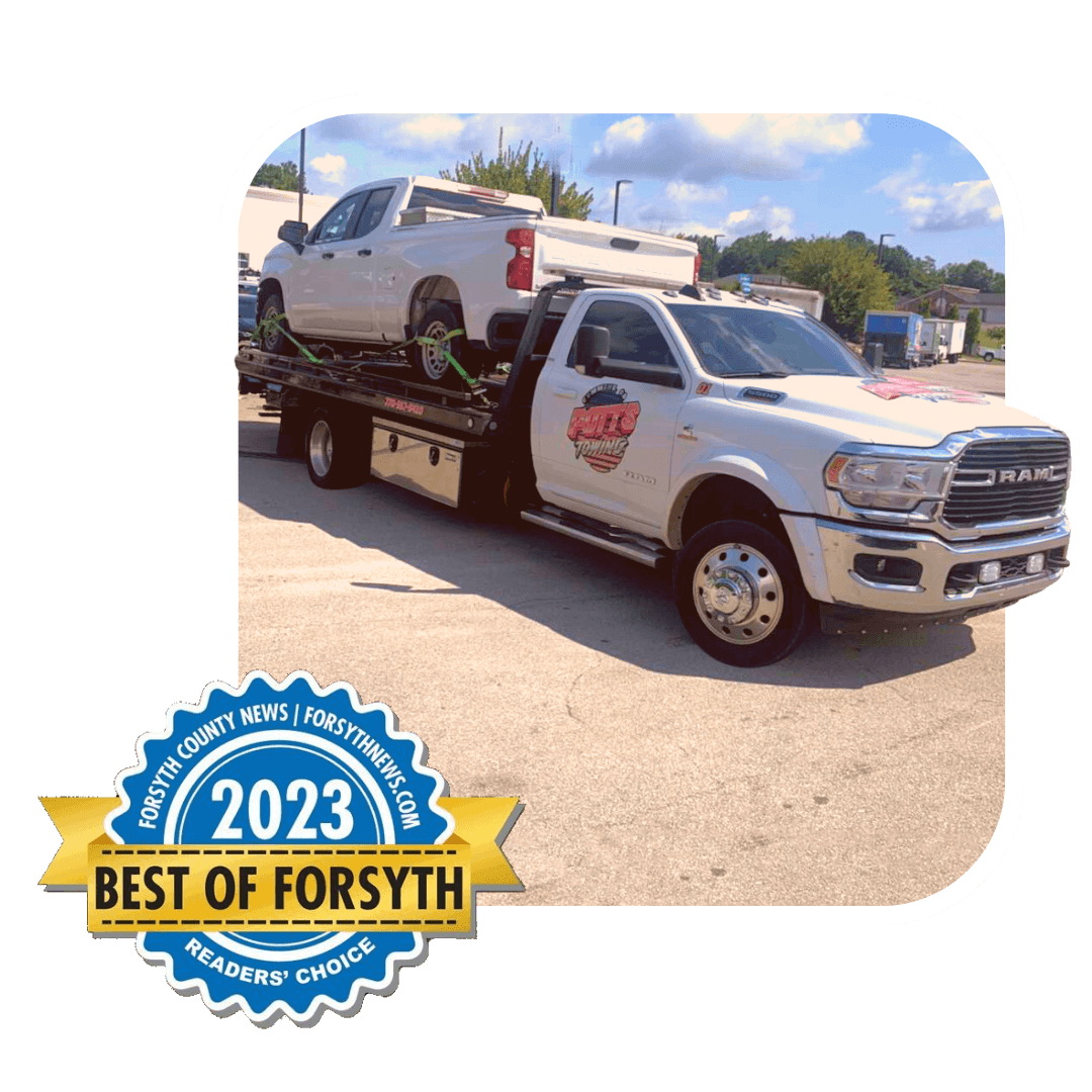 Tow truck carrying a white SUV, with a 2023 Best of Forsyth badge in the corner