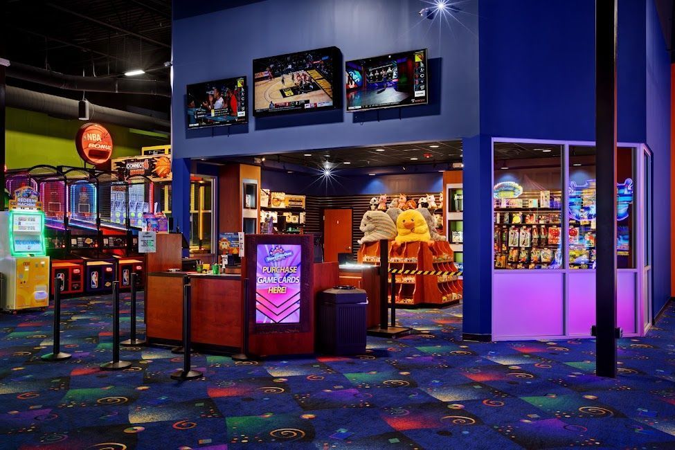 Colorful casino lobby with slot machines, glowing lights, and wall-mounted TVs