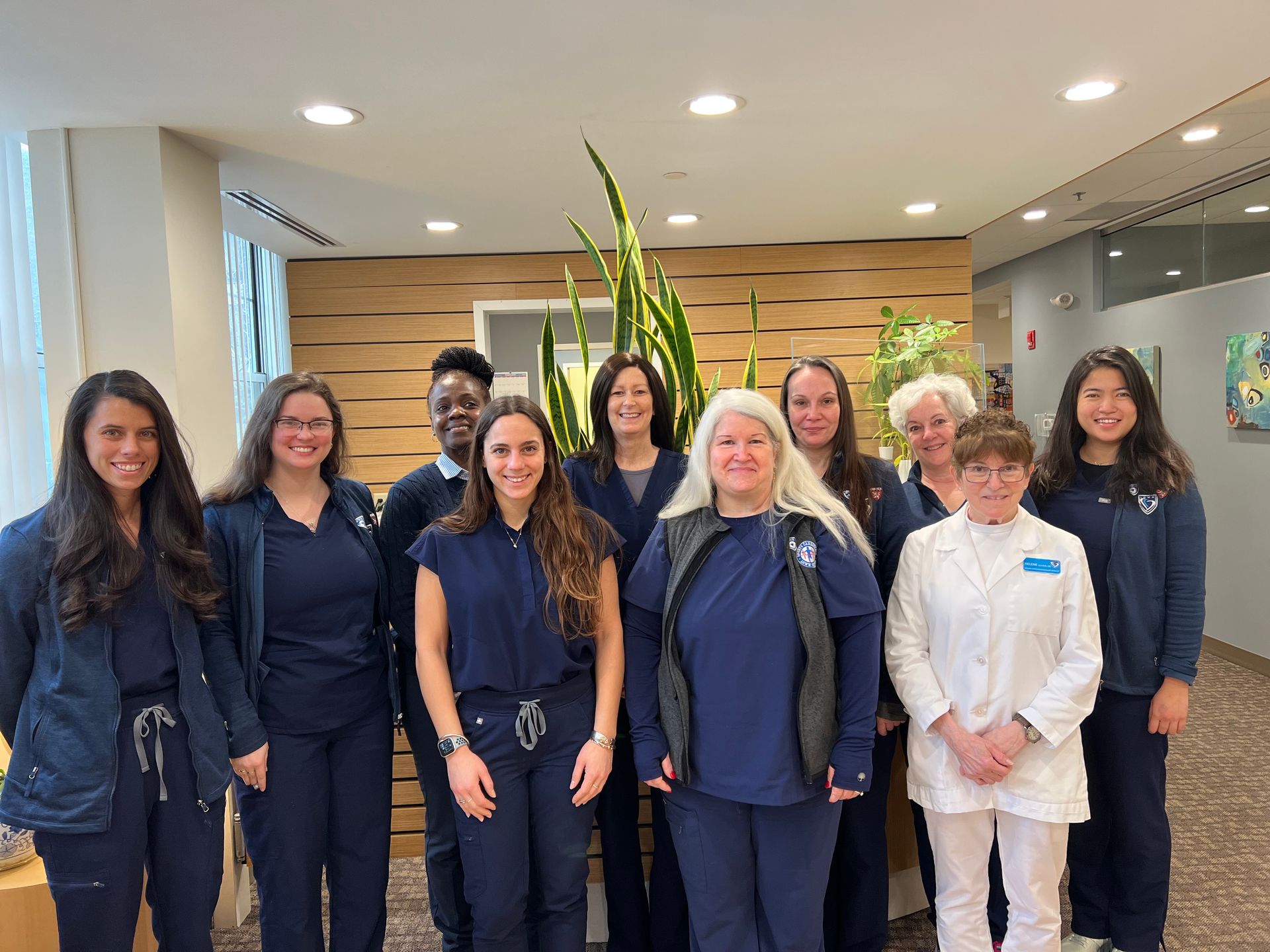 A group of nurses are posing for a picture in a hospital.