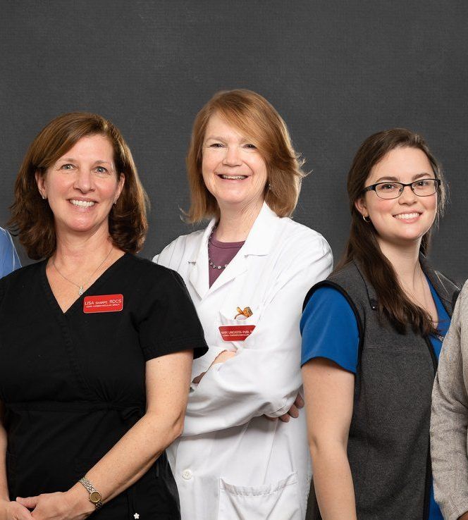A group of female doctors are posing for a picture