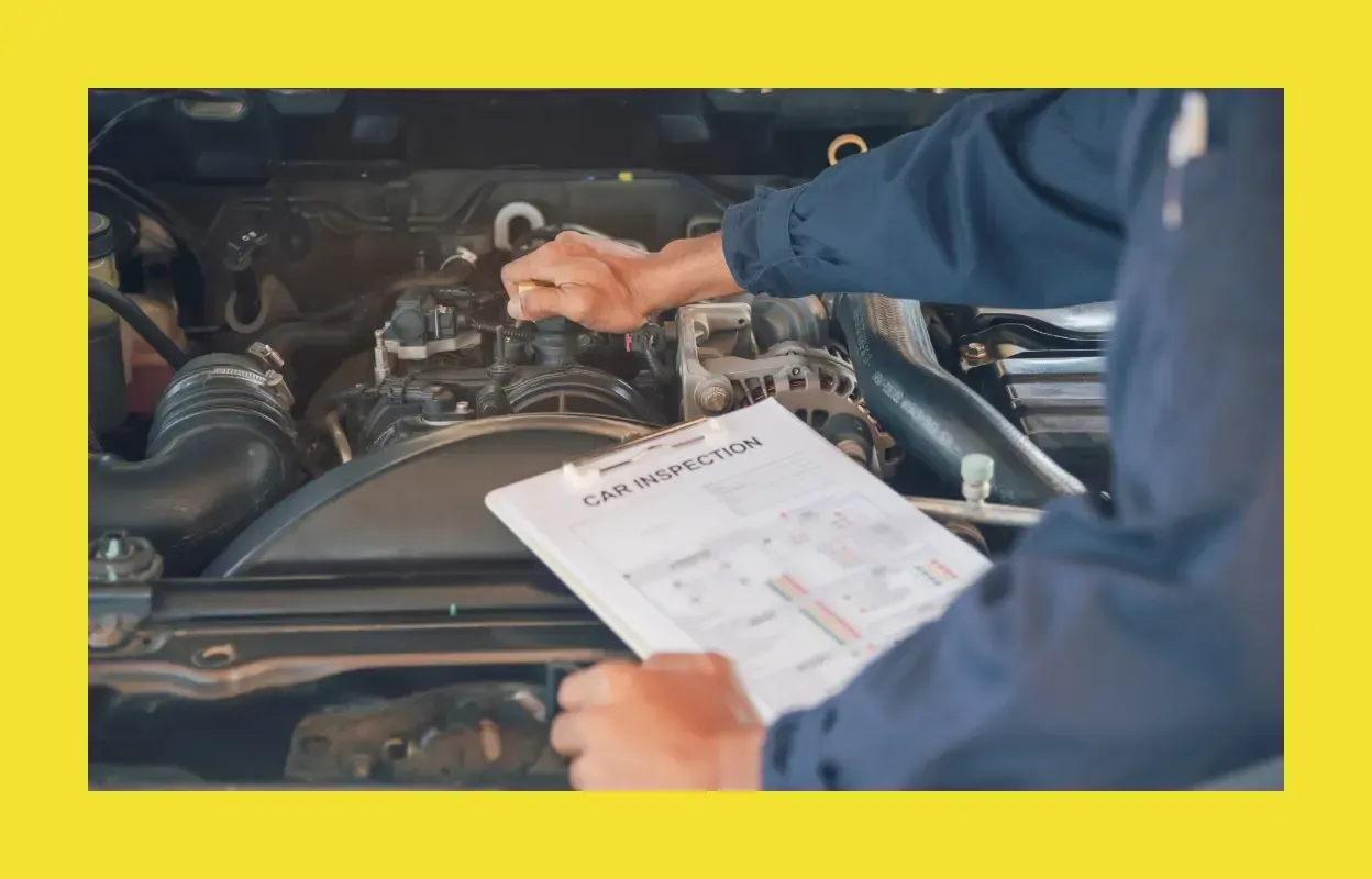 Mechanic performing an inspection on a used car in Longwood, FL
