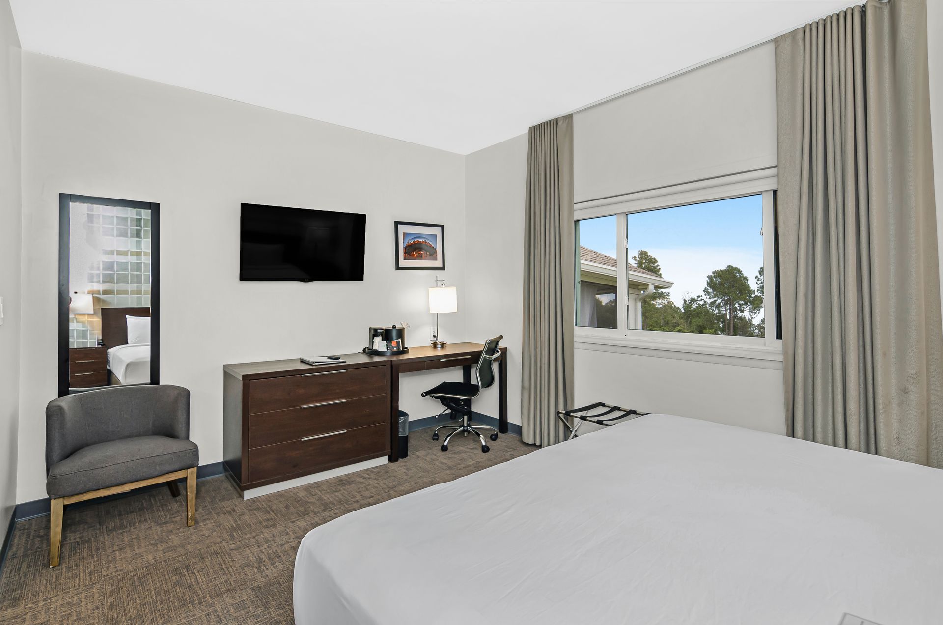 Bright king guest room at Ohio House Motel Chicago with work desk, flat-screen TV and large window