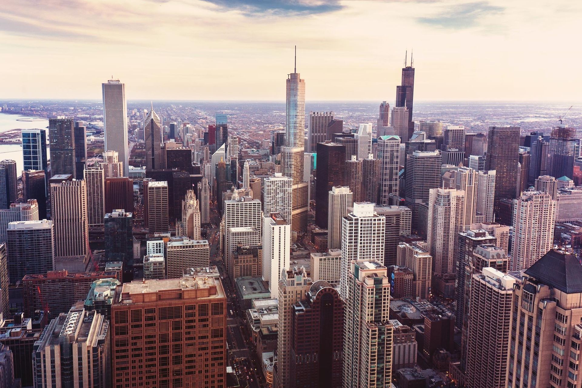 City skyline with numerous skyscrapers under a cloudy sky.