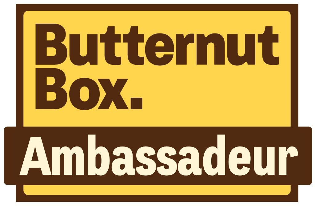 Butternut Box Ambassador logo in yellow and brown text on a white background