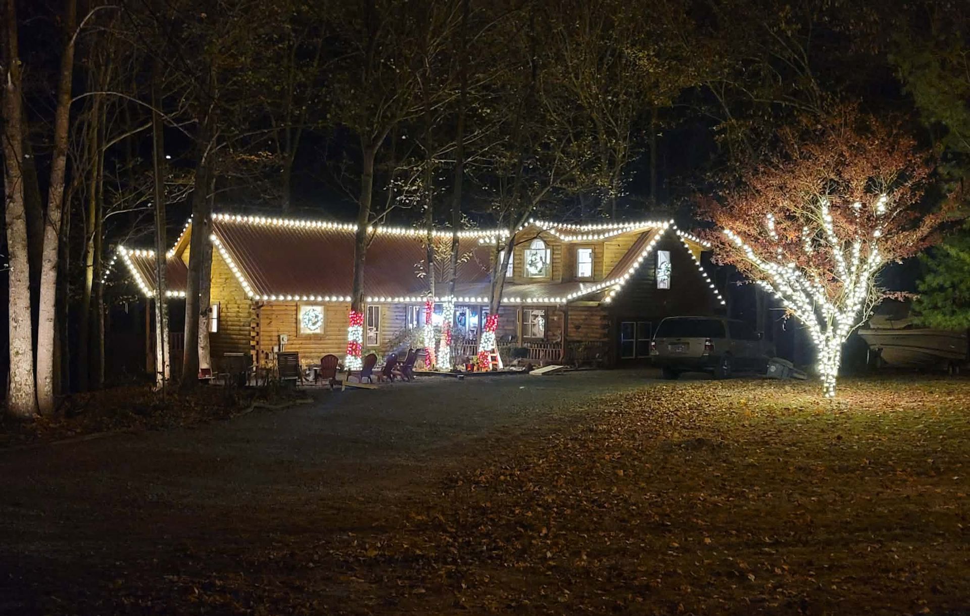 House decorated with white Christmas lights at night.