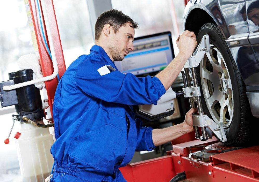 setting up the wheel alignment equipment in a wheel at the Reading workshop