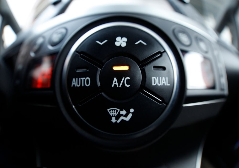 Car air conditioning controls with the A/C button lit