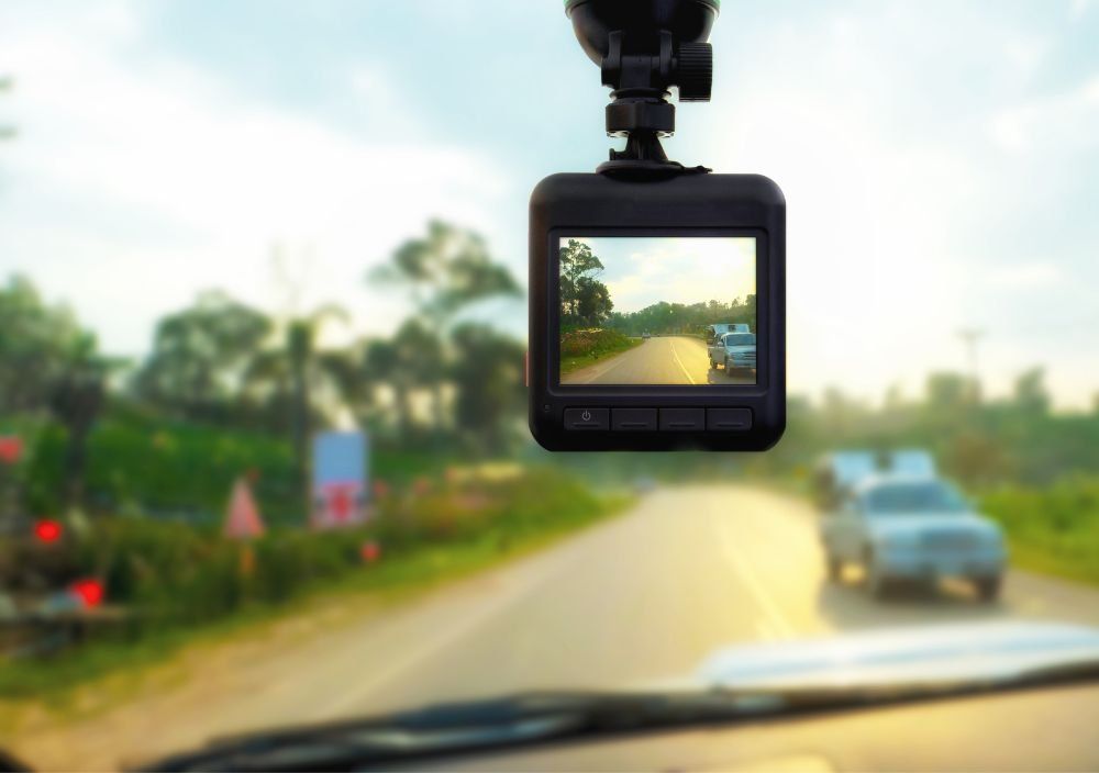 Dash cam mounted on a windscreen, recording the road ahead