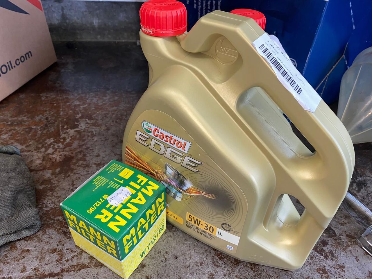 Castrol Edge 5W-30 engine oil and a MANN oil filter on the workbench, ready for a service