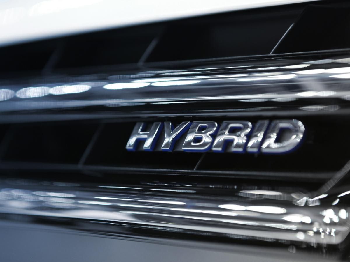 Chrome hybrid badge on the front grille of a car