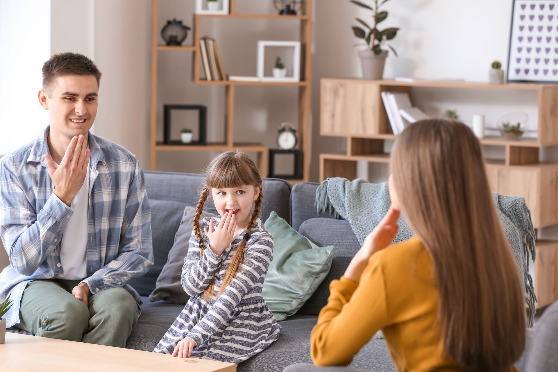 A young family learn how to communicate in sign language together.