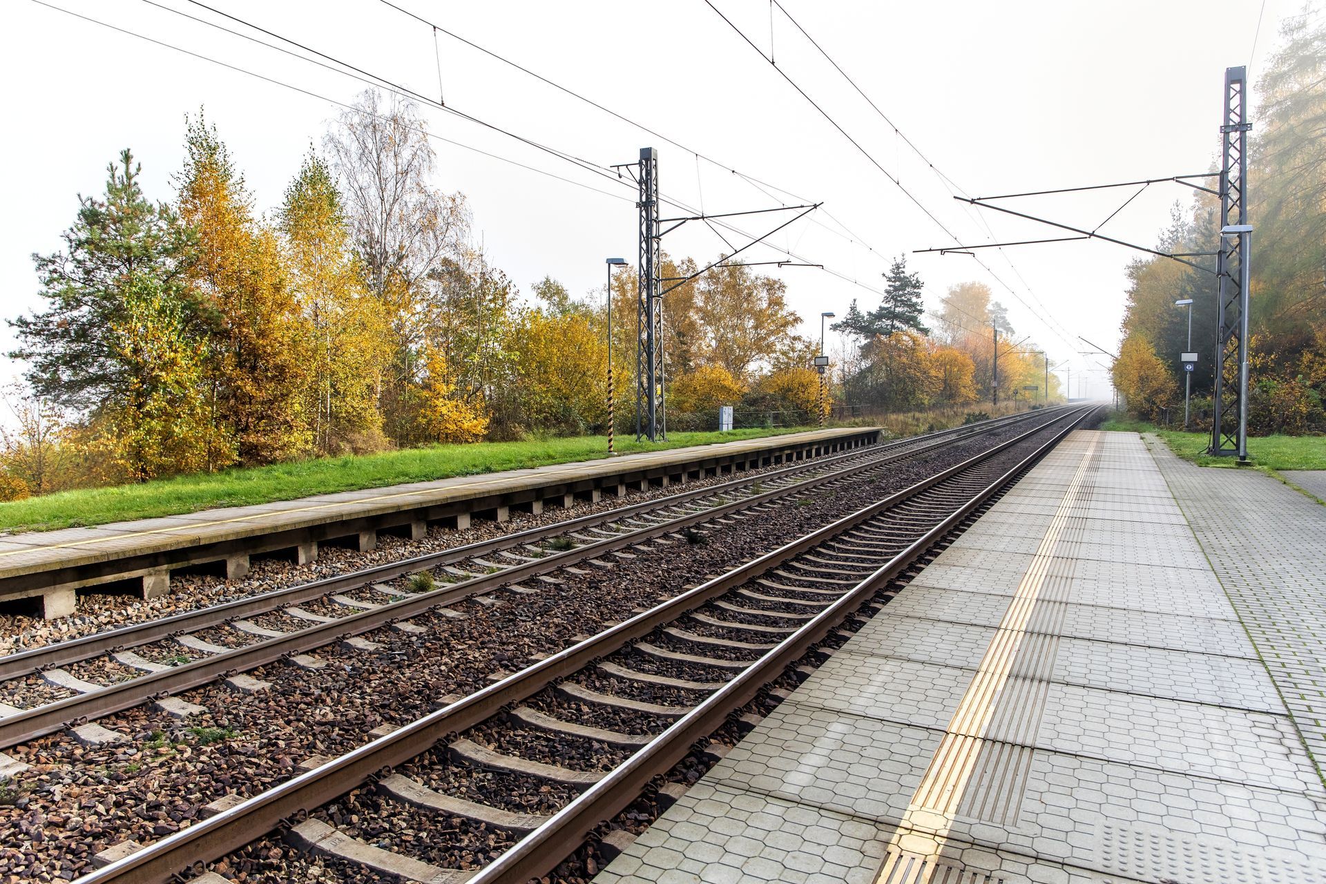 An empty railway platform with no visible accessibility features. 