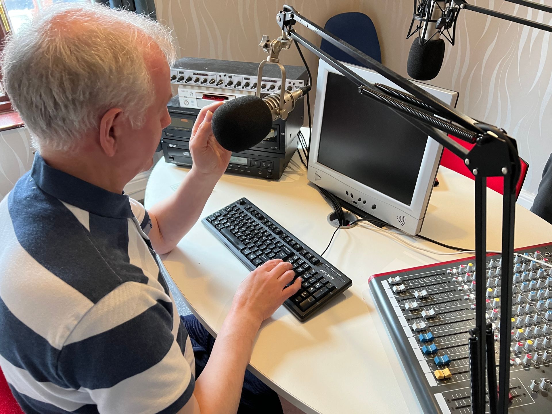 Philip Anderson speaking into his microphone as he records his next Talking Point.