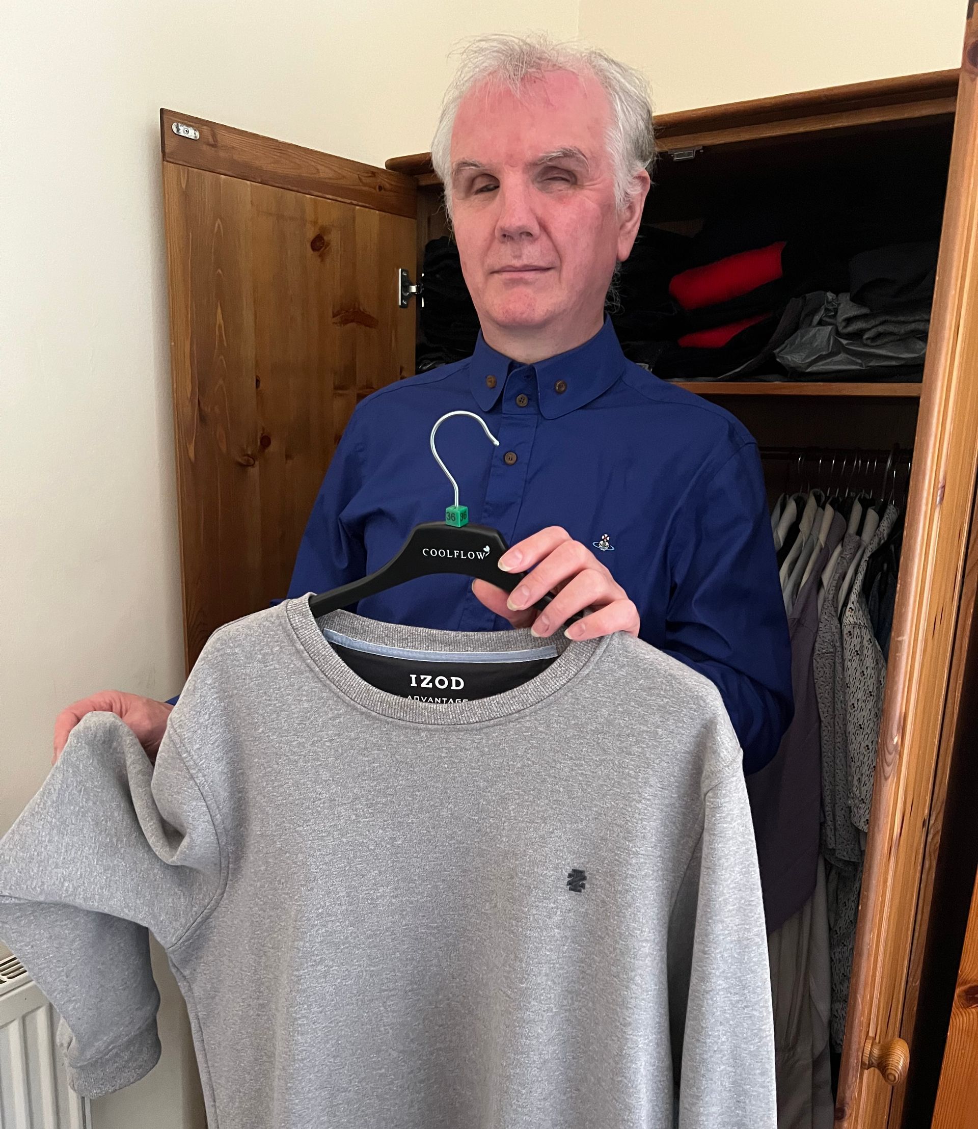 Philip Anderson selects a fleece from his wardrobe using the texture of the material.