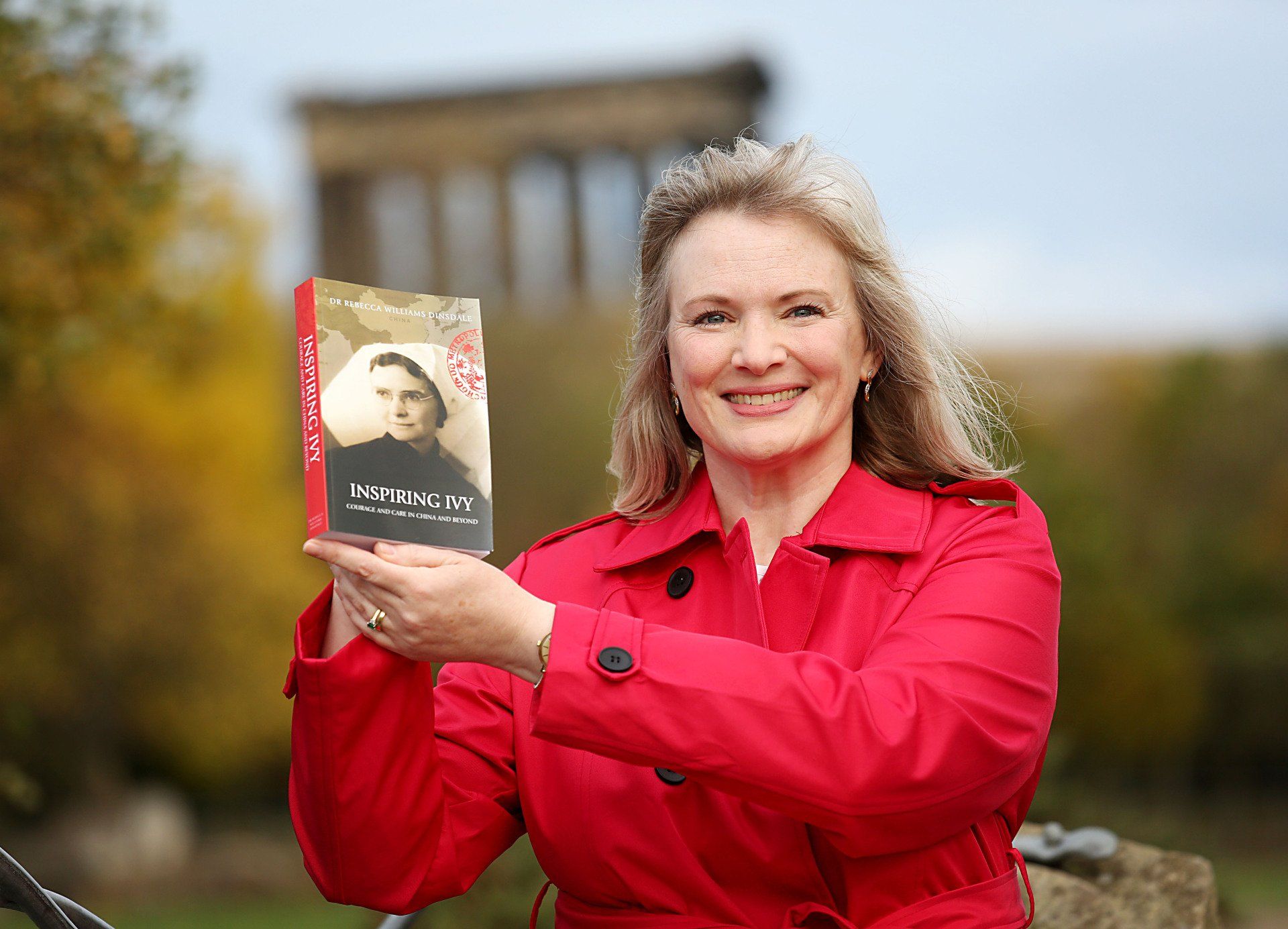 Bec smiling and holding up the Inspiring Ivy book