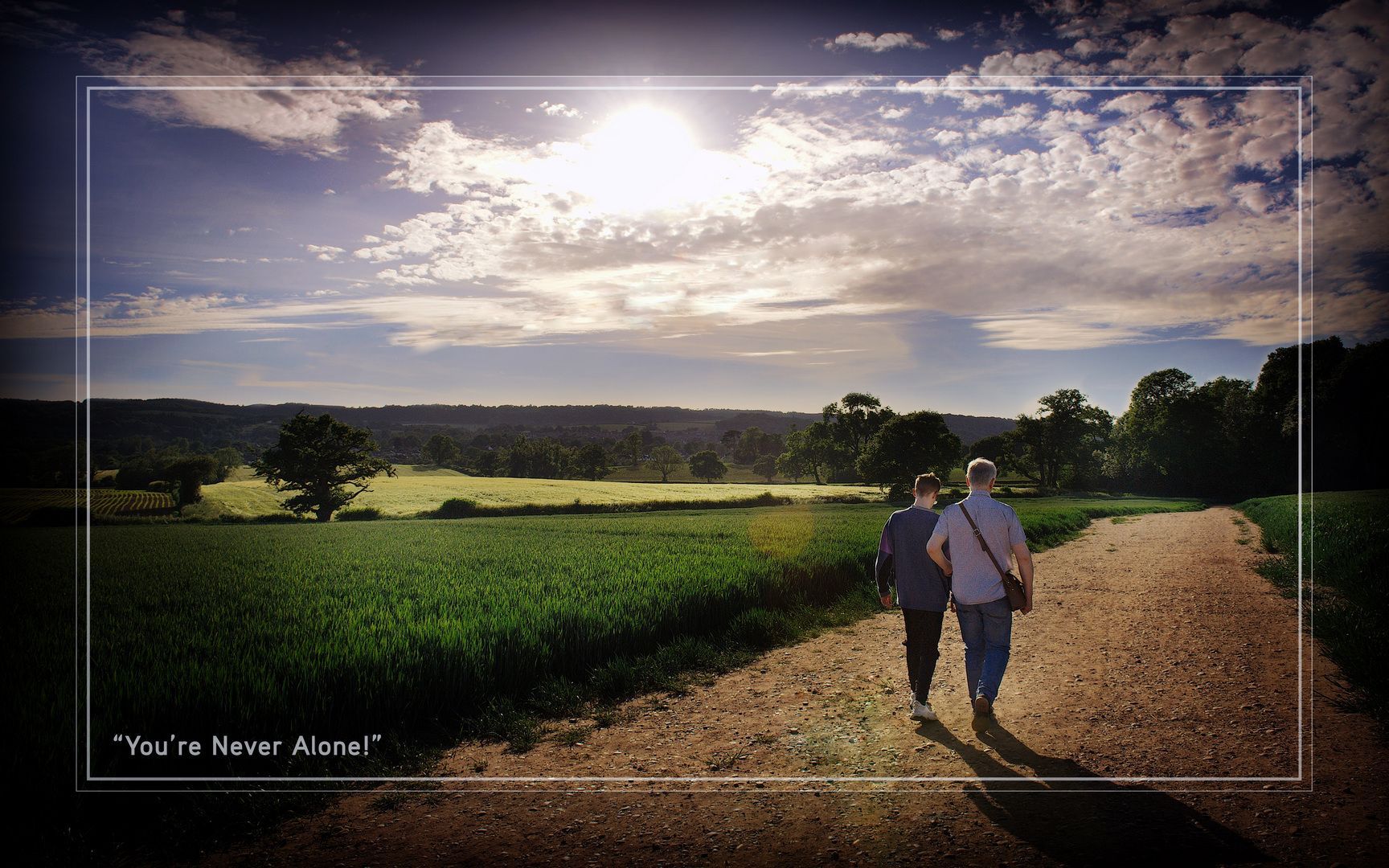Philip Anderson and his son on Barlaston Downs, wandering through the cornfield under a setting sun.