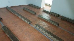 A room with a lot of wooden boards on the floor.