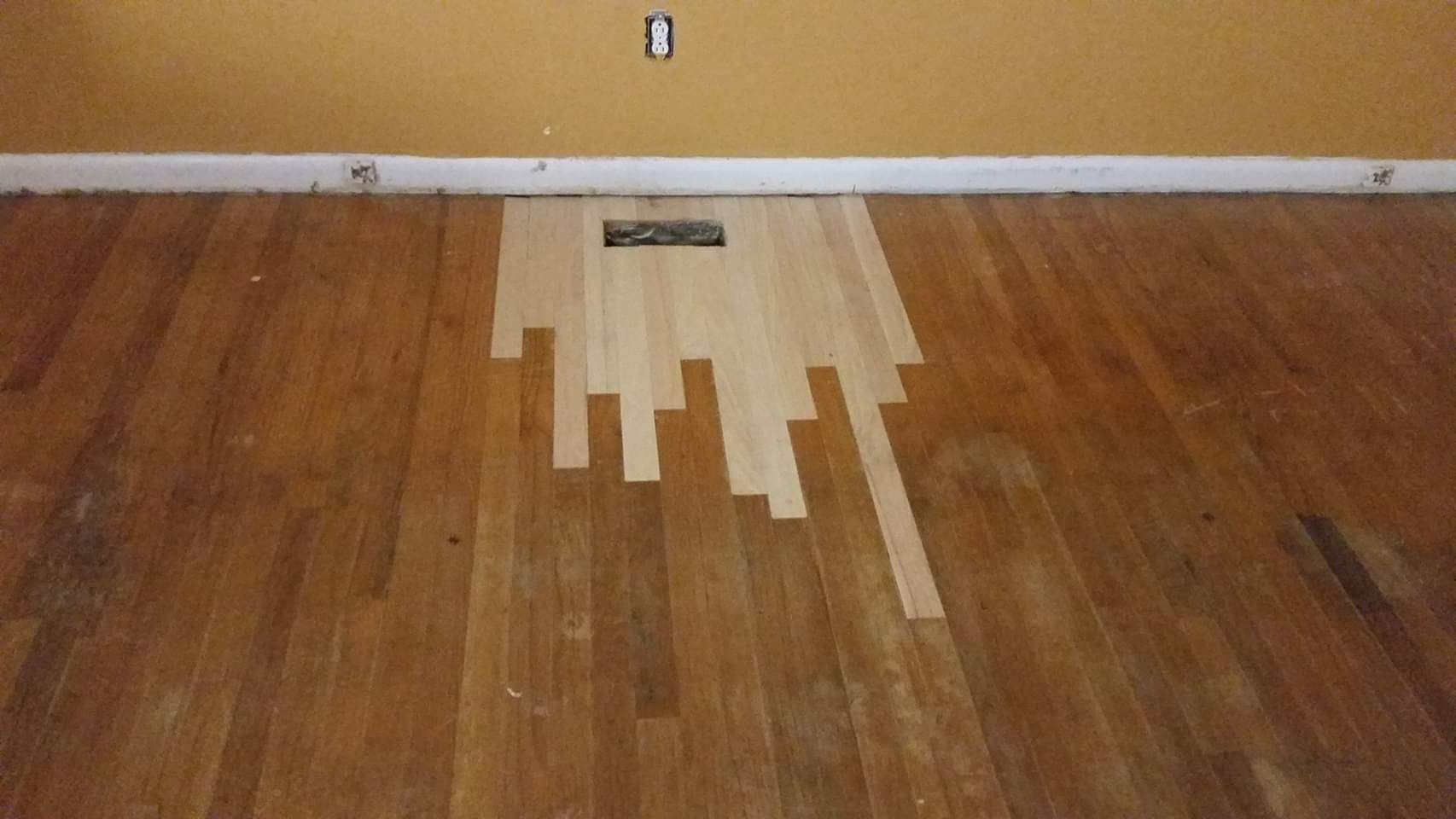 A wooden floor with a few pieces of wood on it