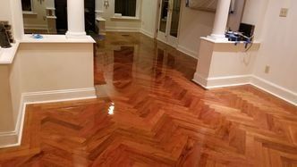 A living room with hardwood floors and white walls.