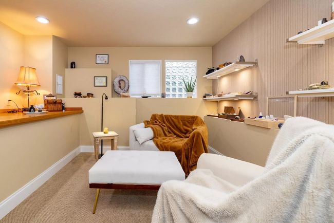 Soothing room with warm lighting, neutral tones and comfortable chairs