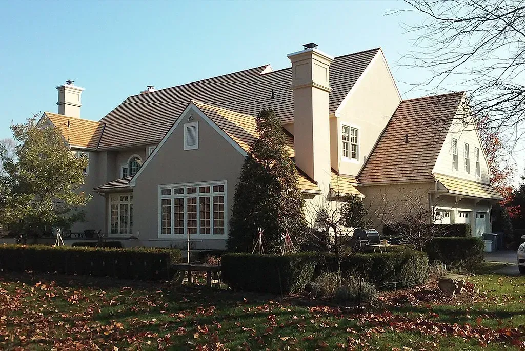A white house with a black roof and solar panels on the roof - Holland, PA - Esh Home Improvement LLC