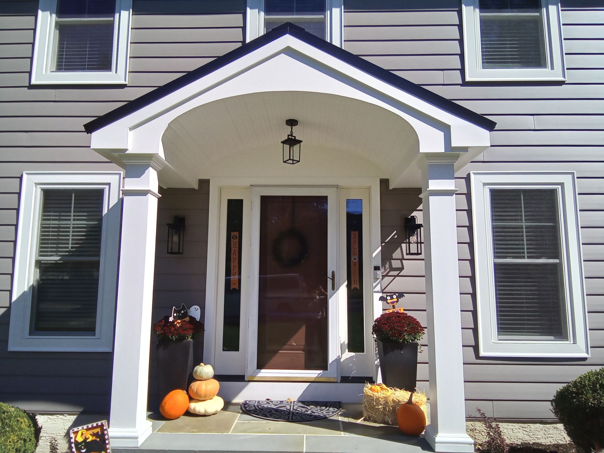 A house with arched windows and a garage door - Holland, PA - Esh Home Improvement LLC