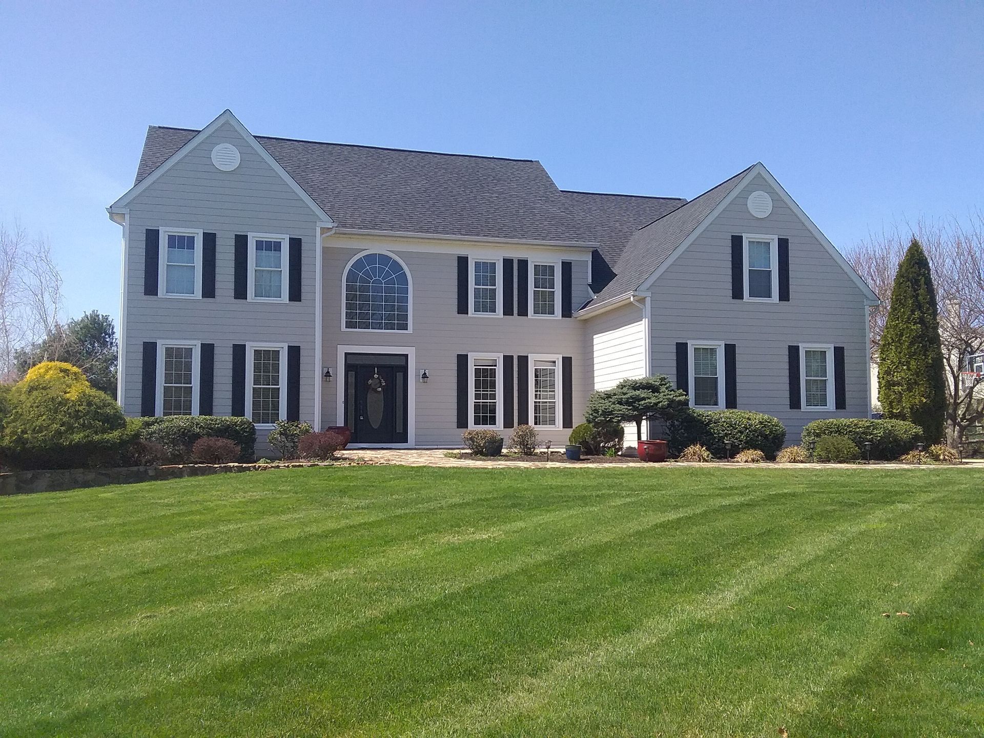 A large house with a brown roof and white trim - Holland, PA - Esh Home Improvement LLC