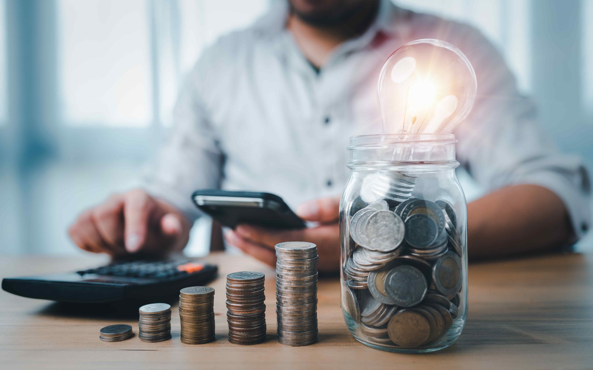 Man With Calculator Saving Money On Energy Bills