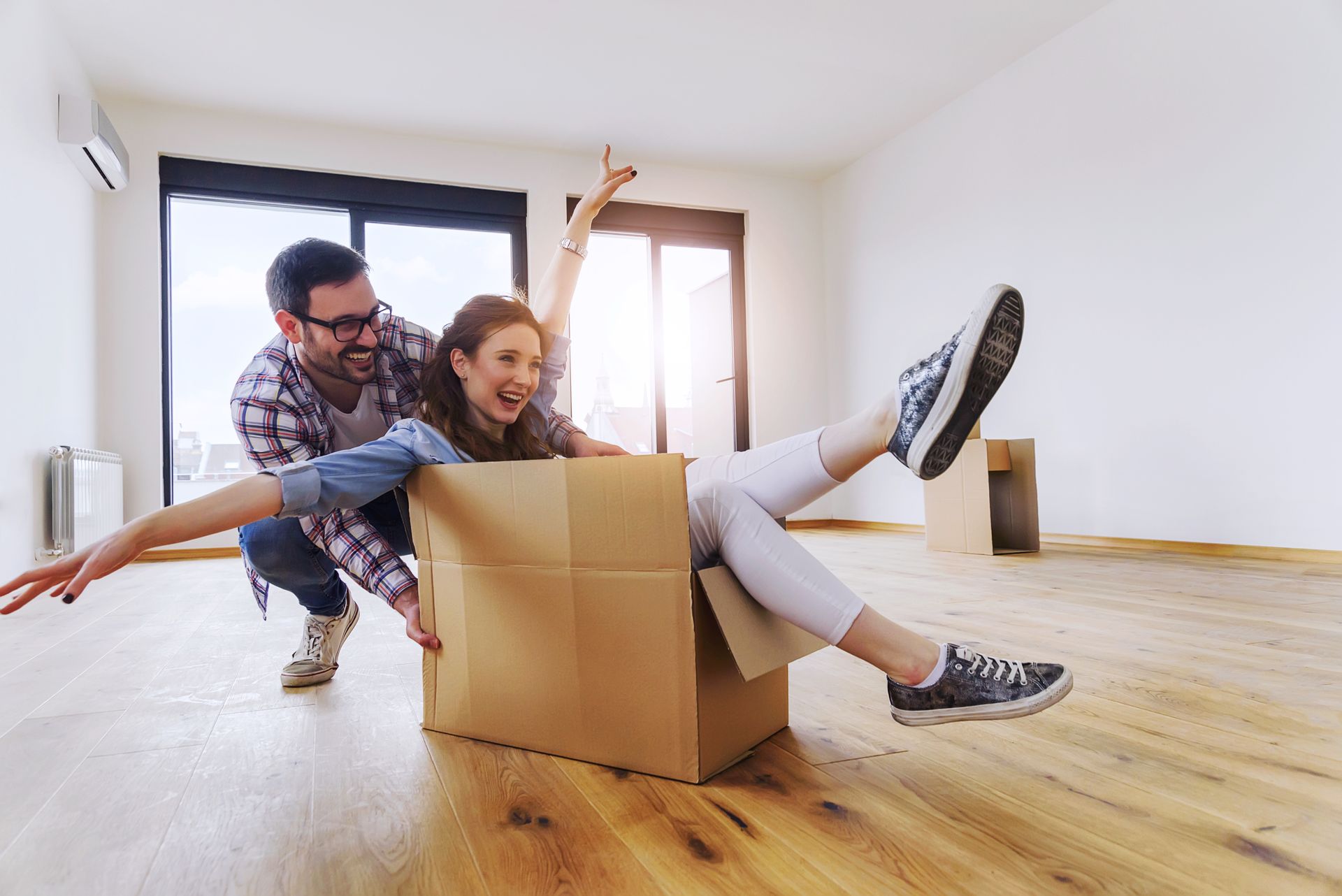 Husband and Wife Packing Boxes To Relocate
