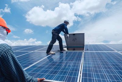 Solar Technician Reinstalling Solar Panels