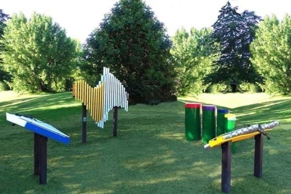 Outdoor fitness trail with exercise equipment in a park