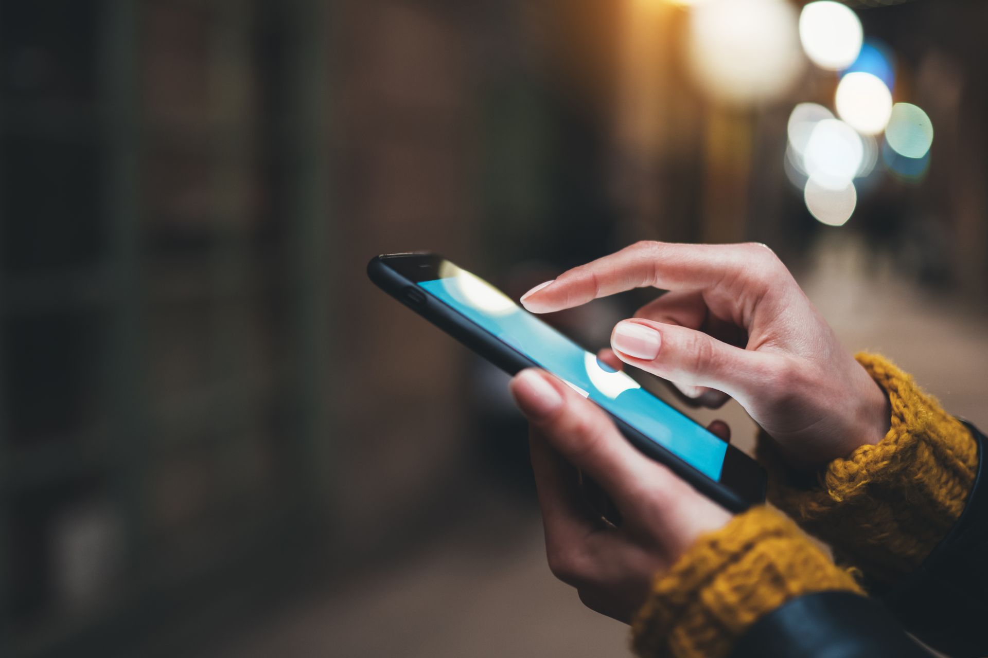 A person is holding a mobile in their hands. Checking for the best deals.