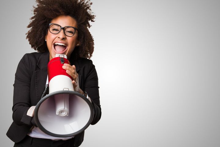 A woman is holding a megaphone with her mouth open shouting Let's Talk.