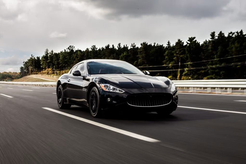 black car driving on the road