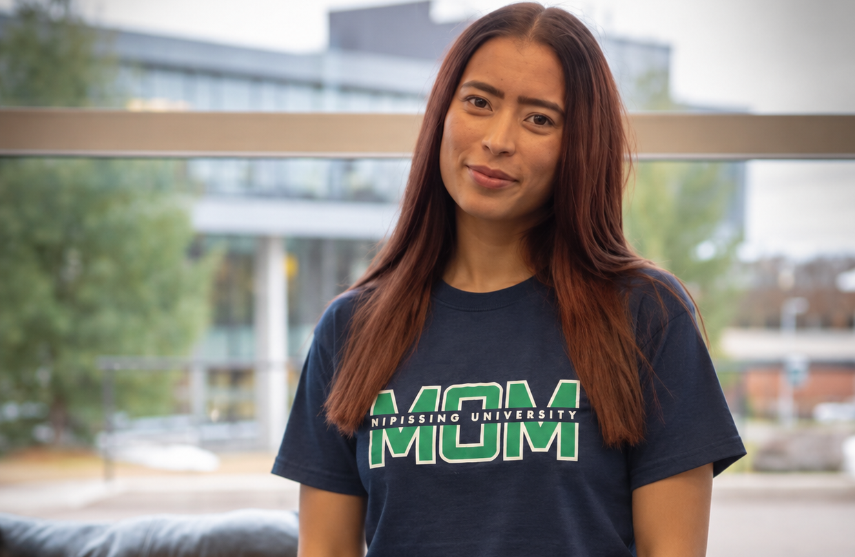 Woman in navy/green 