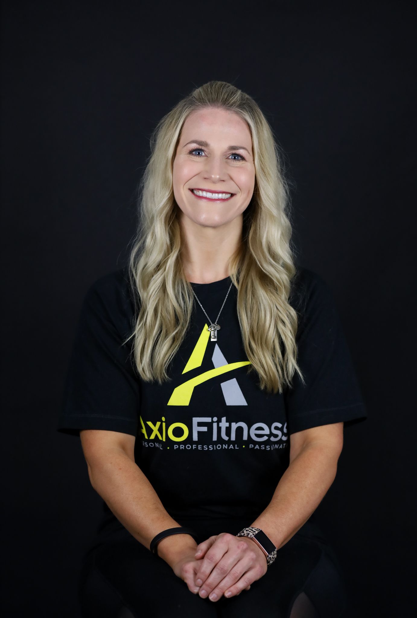 Woman with long blonde hair wearing a black t-shirt with 