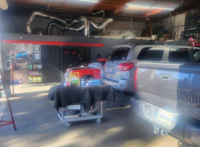 A toyota truck is parked in a garage with other cars