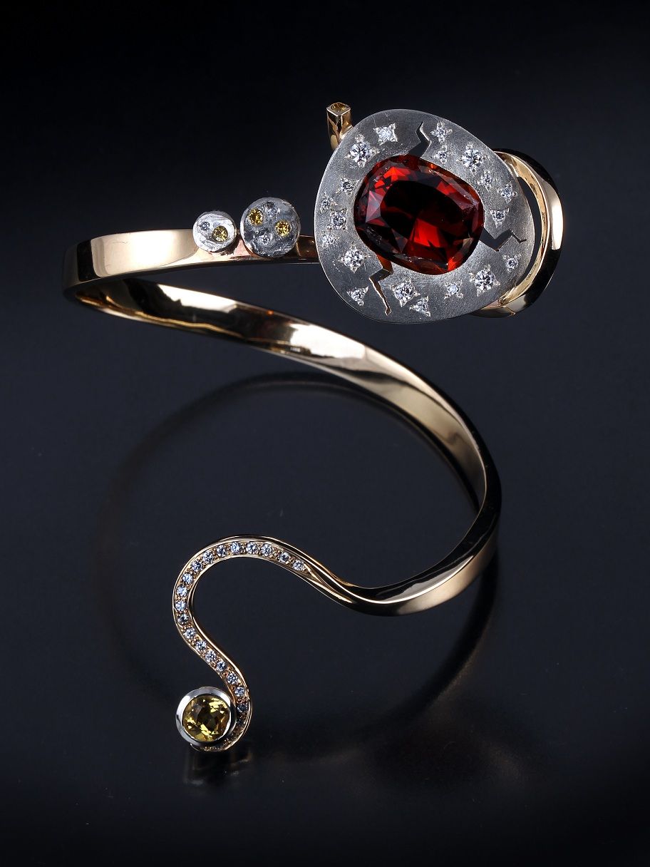 A gold ring with a red stone in the center