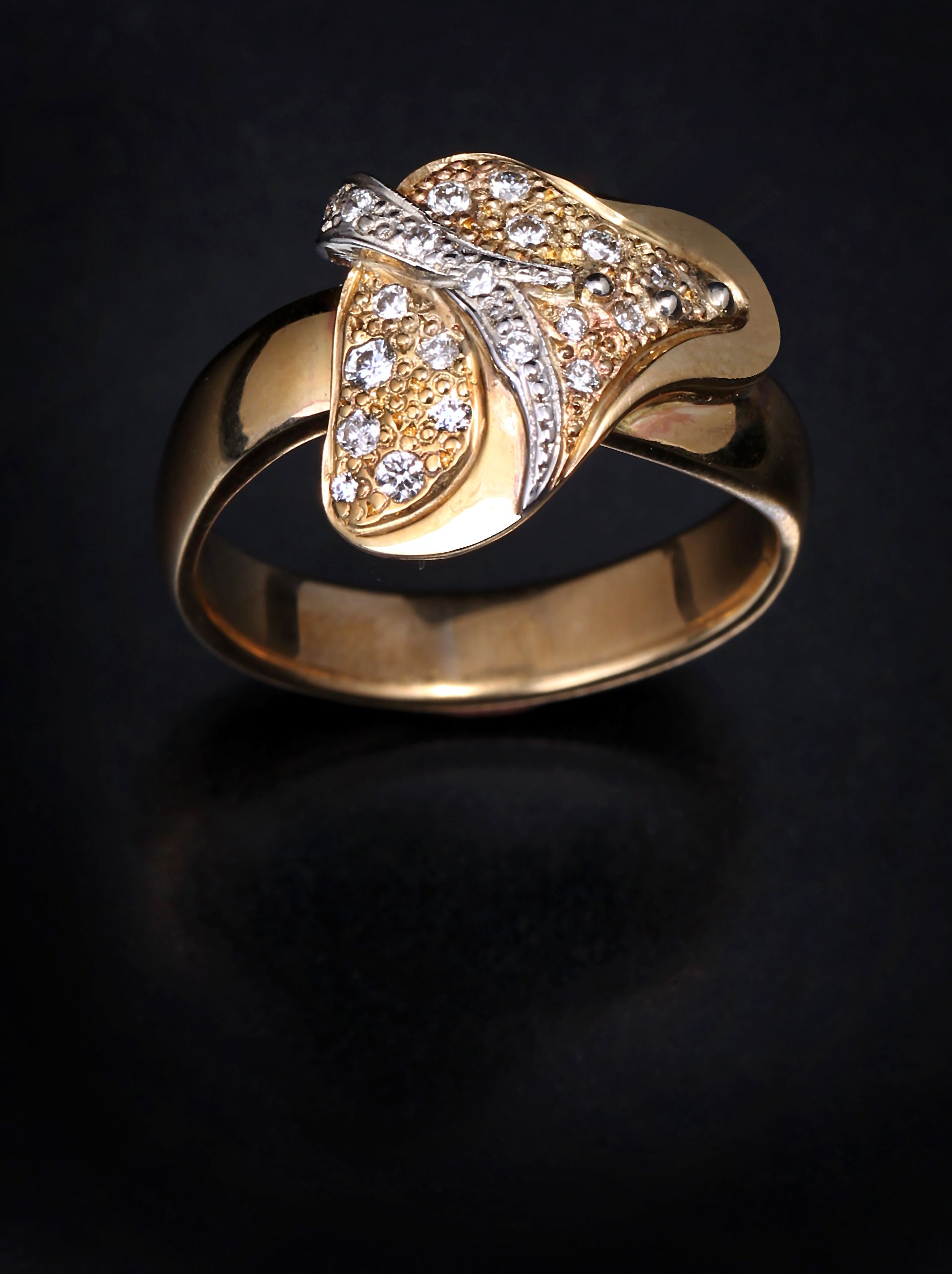 A gold ring with diamonds on a black background