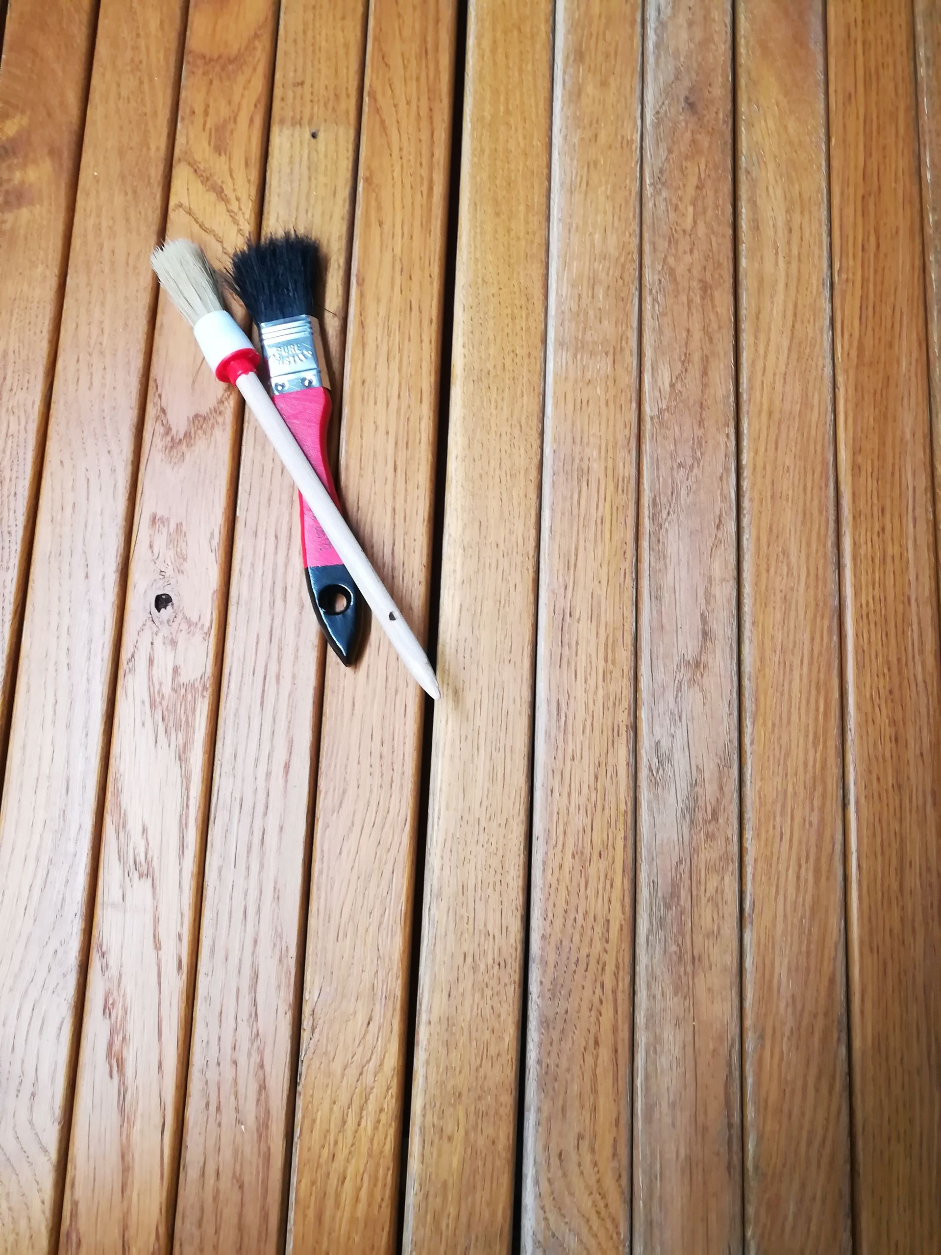 A wooden table with a brush on it