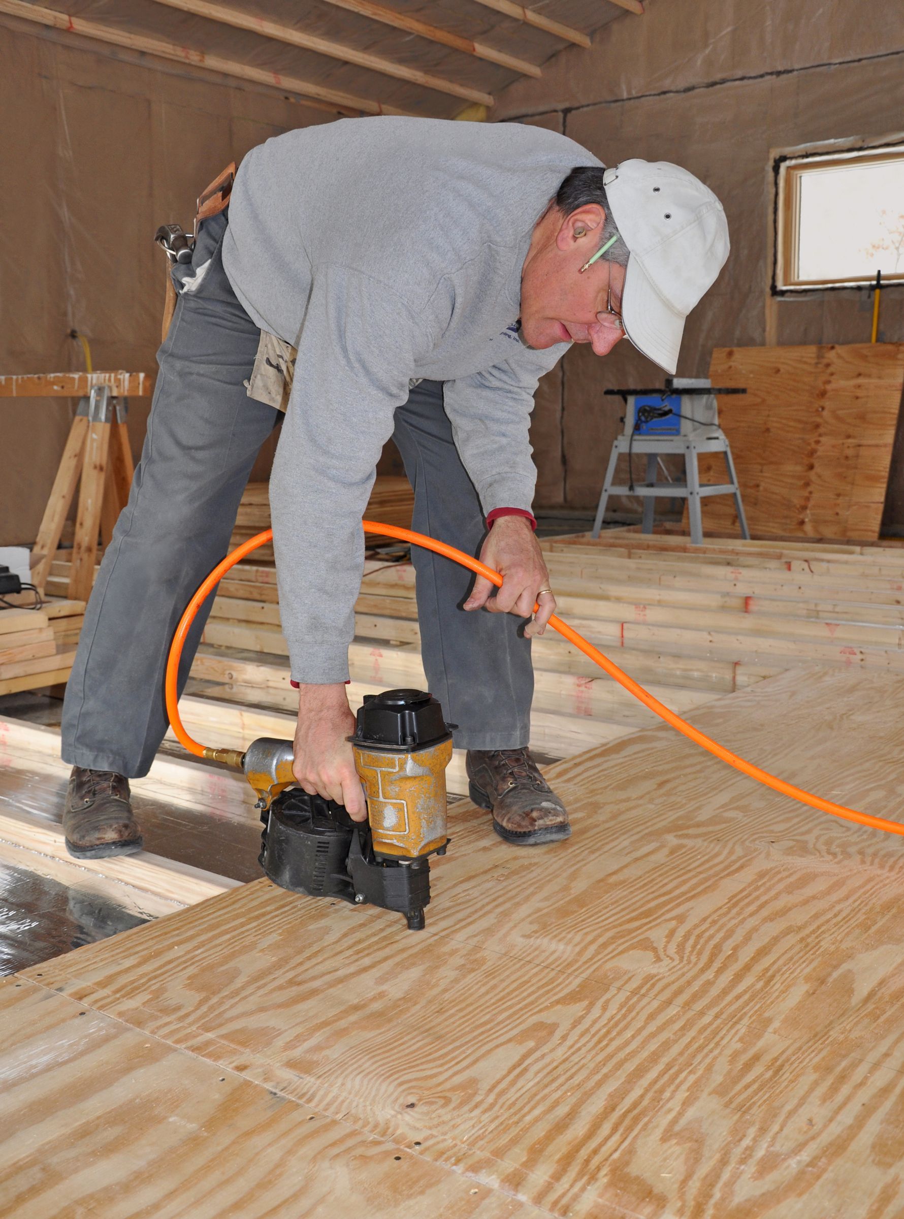 man installing subfloor